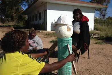 Yalata artists who collected the marine debris during the beach clean up near the Head of the Bight, discuss the design for a marine debris man sculpture.