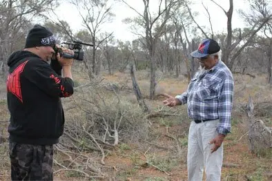 Richard Wilton filming Workshop Facilitator Roy Coulthard explaining how the punu is collected. 