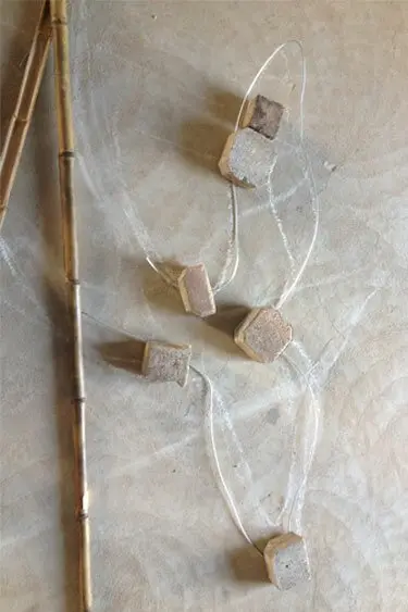 The Whale's tail outlined in fencing wire on the workshop floor.