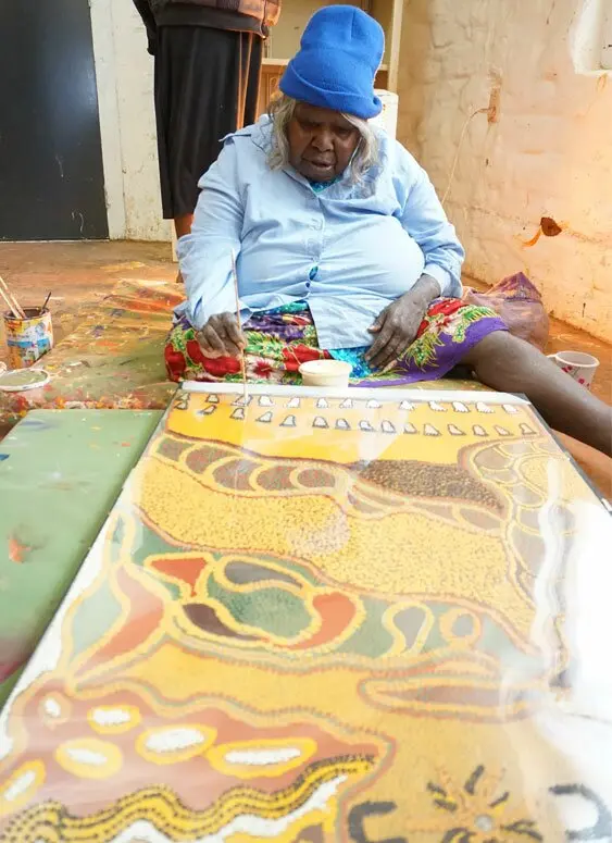 Nyanu Watson working on a design for a silk screen print at Ninuku Arts